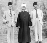 Haj Mohammed Effendi Amin el-Husseini (Arabic: محمد أمين الحسيني‎, Muhammad Amin al-Husayni; born between 1895 and 1897; died July 4, 1974) was a Palestinian Arab nationalist and Muslim leader in the Mandatory Palestine.<br/><br/>

Al-Husseini was an Arab nationalist and following the end of the First World War positioned himself in Damascus, as a supporter of the Arab Kingdom of Syria. However, following the fiasco of the Franco-Syrian War, his positions on pan-Arabism shifted to a form of local nationalism for the Arabs of Palestine and he moved back to Jerusalem. From 1921 to 1937 al-Husseini was the Grand Mufti of Jerusalem, using the position to promote Islam and rally Arab nationalism against Zionism.<br/><br/>

During the 1948 Palestine War, Husseini represented the Arab Higher Committee and opposed both the 1947 UN Partition Plan and King Abdullah's entente with Zionists to annex the Arab part of British Mandatory Palestine to Jordan. In September 1948, he participated in the establishment of an All-Palestine Government. Seated in Egyptian ruled Gaza, this government won a limited recognition of Arab states, but was eventually dissolved by Gamal Nasser in 1959.